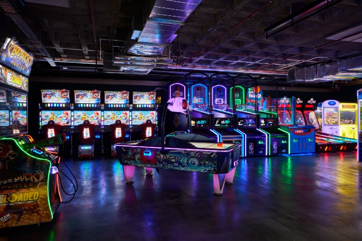 Vintage arcade games and air-hockey table with coloured lights at B Lucky & Sons