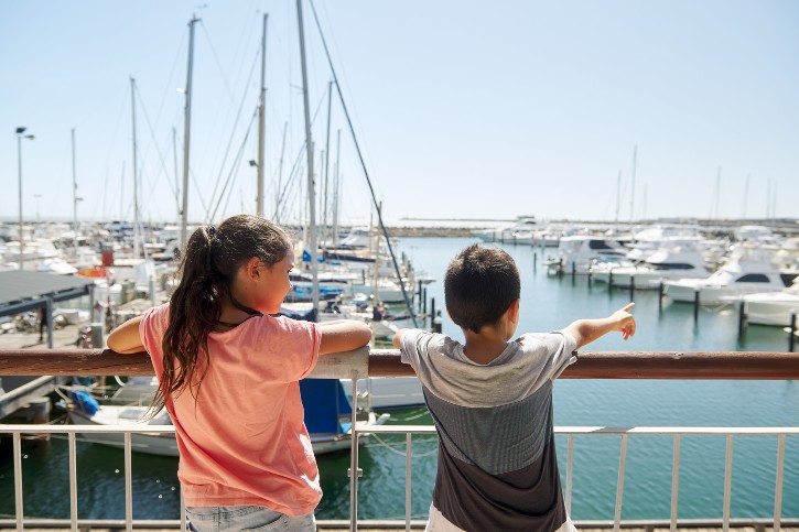 A young boy and girl at Be.Fremantle looking at the marina