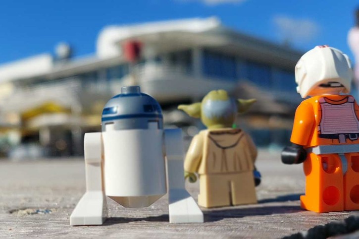 star wars lego characters stand in front of Bathers Beach House with blue sky