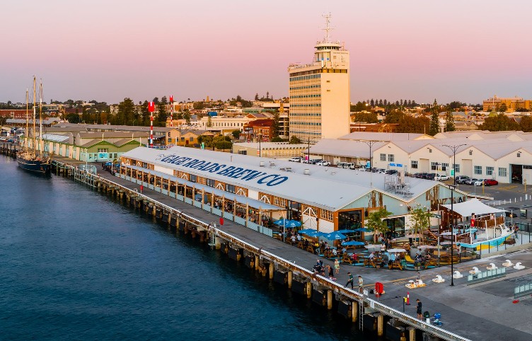aerial view of waterfront warehouse 'GAGE ROADS FREO' venue at sunset