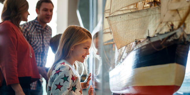 Child beams at model ship in WA Maritime Museum