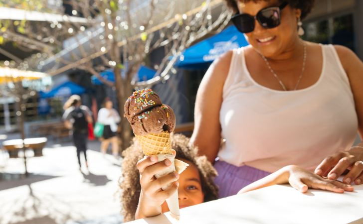 Happy kid grabs their chocolate ice cream with sprinkles at FOMO Fremantle