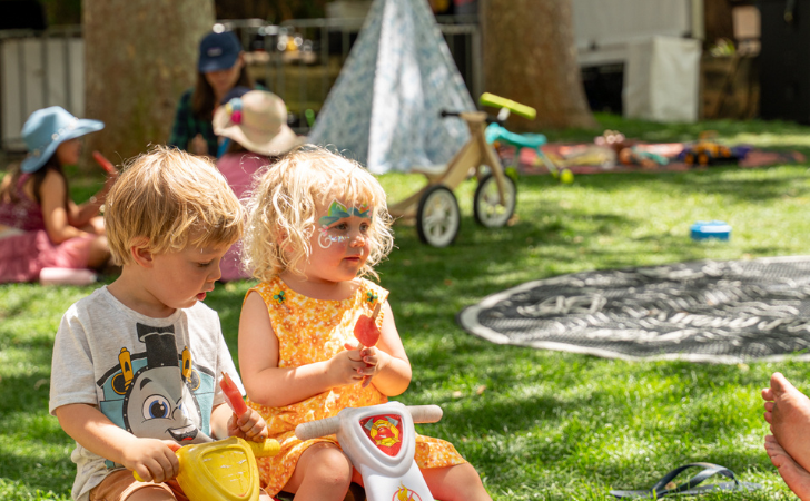 two kids play in Fremantle Arts Centre's lawn