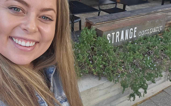 Alex Crisp selfie in front of Strange Company