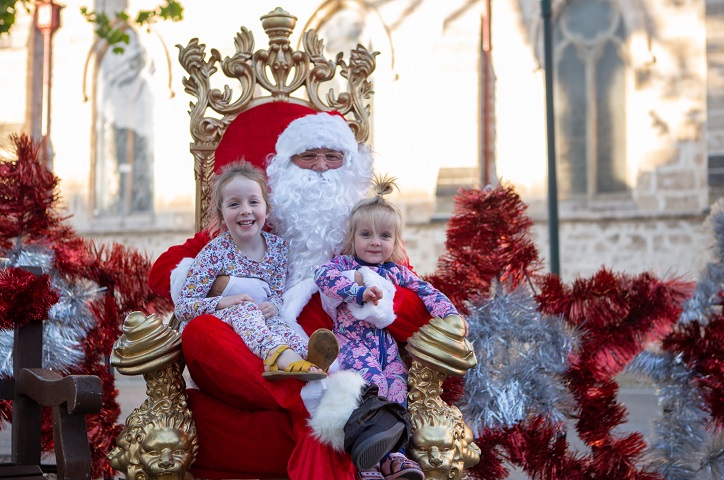 Two children meeting Santa in Walyalup Koort.