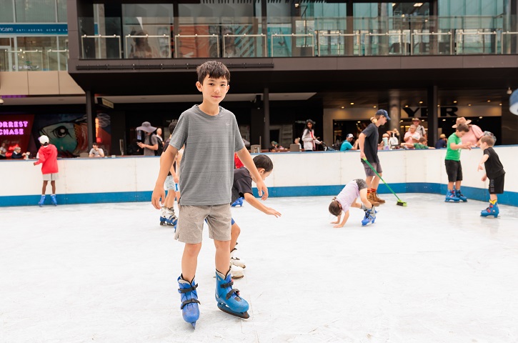 Child skating on rink.