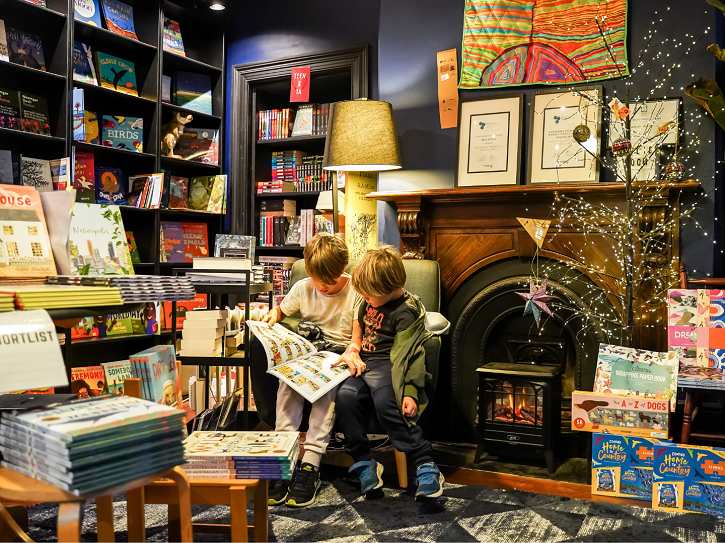 Children reading inside Paper Bird Children's Books & Art