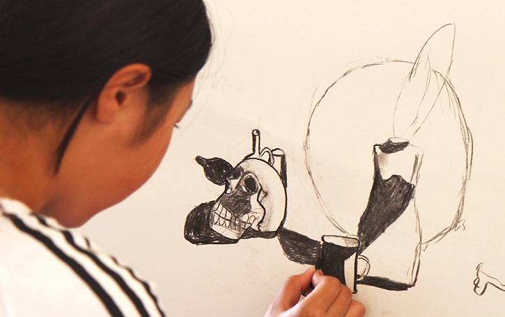 Young child completing a still life drawing.