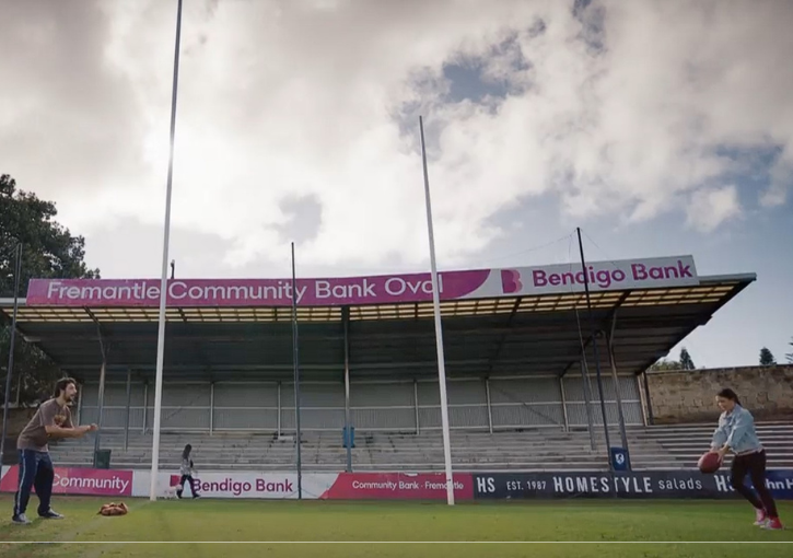 Charlie and Kiah from Reckless kicking a ball