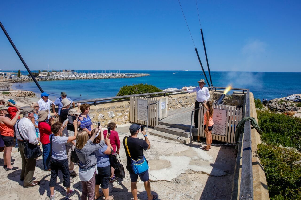 tourists watching the cannon be fired at the roundhouse