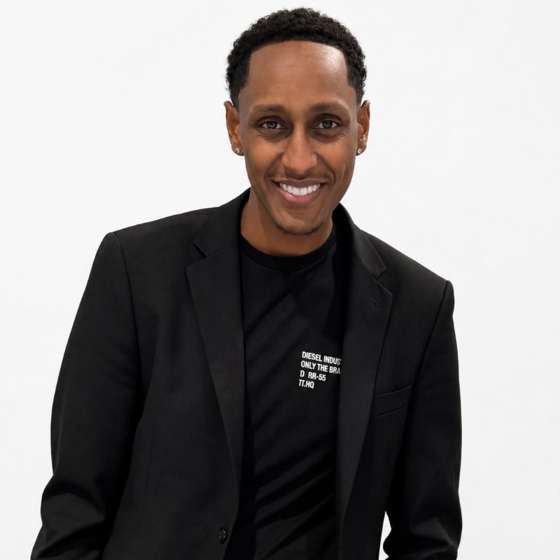 a man in a black suit on a white background