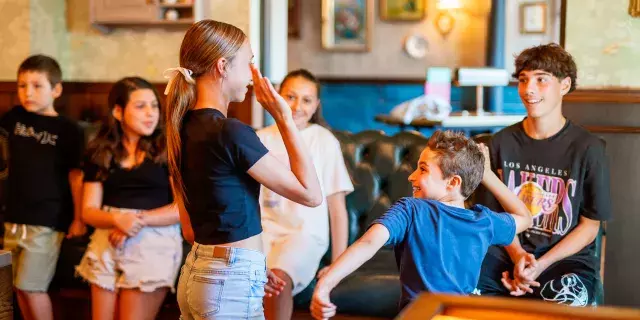 Flight Club school holidays - children about to high-five each other