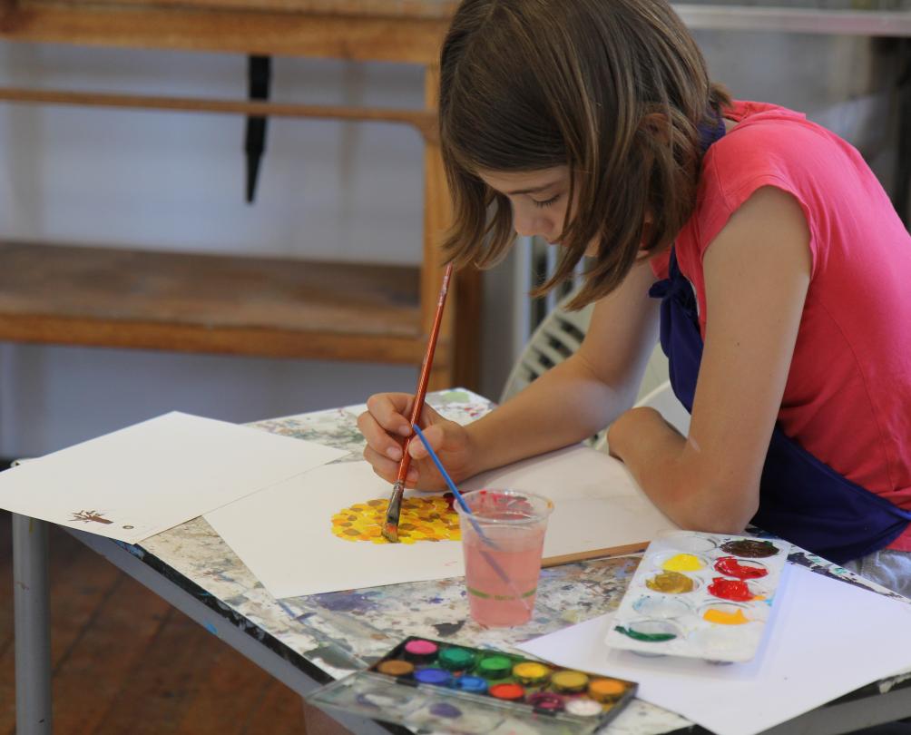 Young girl in pink t-shirt painting at Fremantle Arts Centre