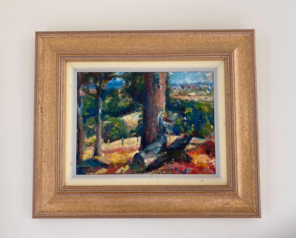 Artwork of a tree and landscape in a wooden frame