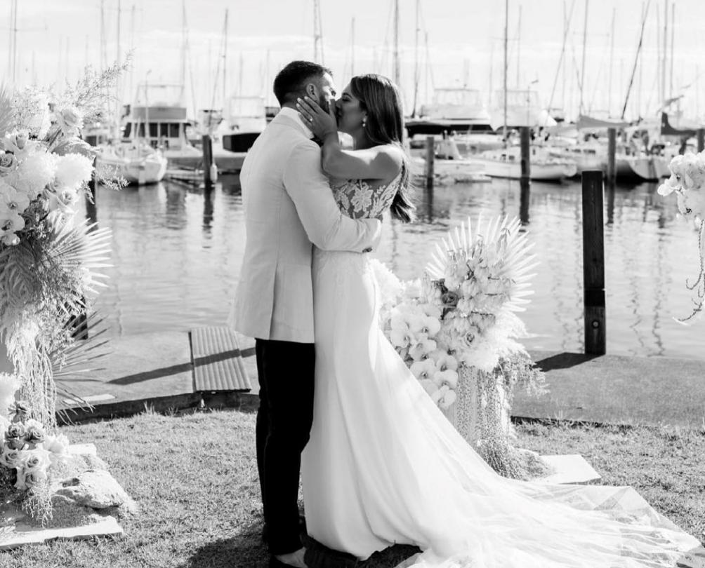 man and a woman sharing their first kiss after a wedding ceremony held at the fremantle sailing club