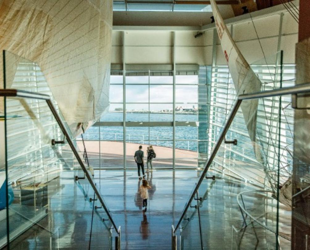 family looks out to ocean from huge maritime museum
