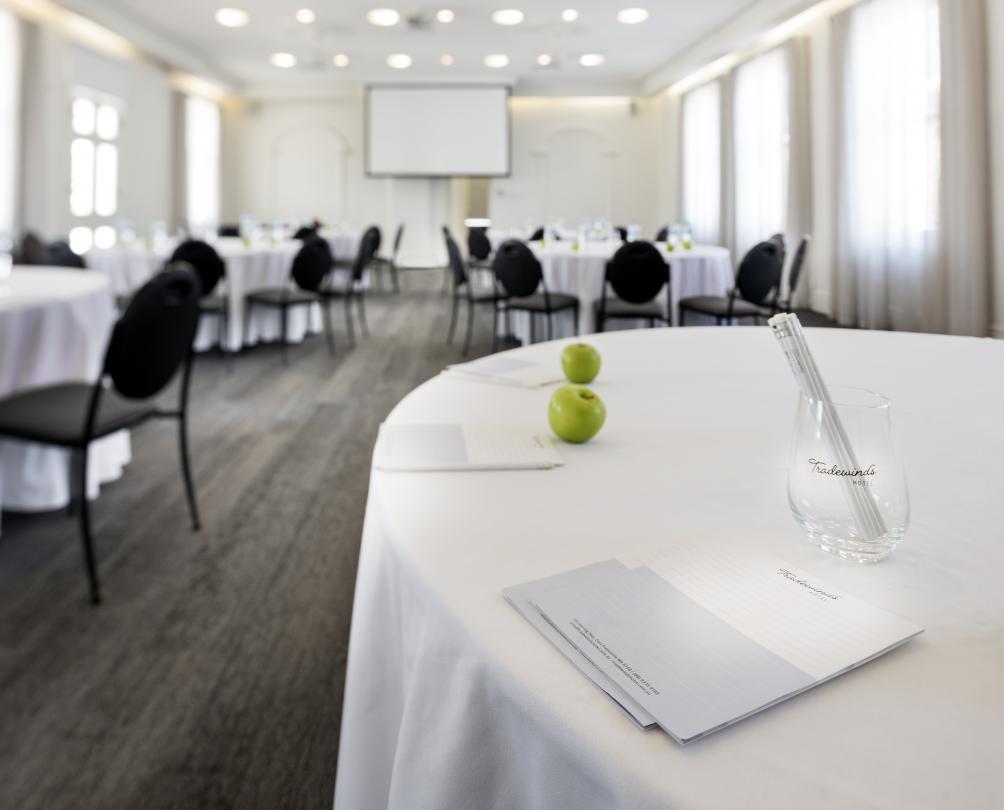 Large white room set with conference tables and chairs