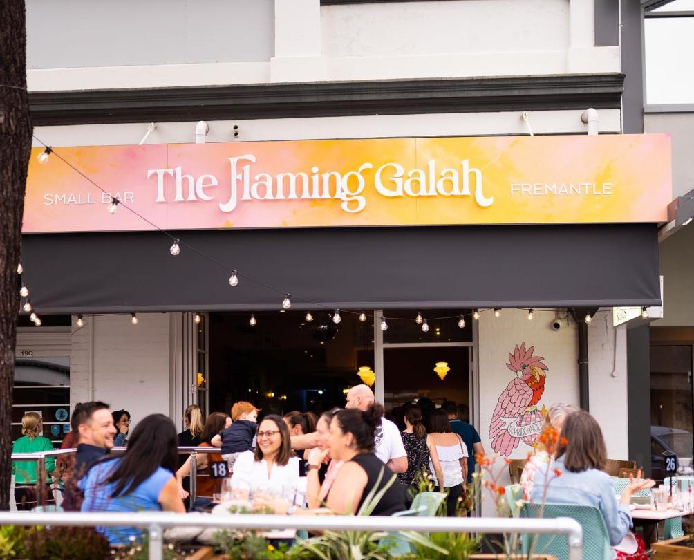 Exterior shot of The Flaming Galah with people seated at tables out the front