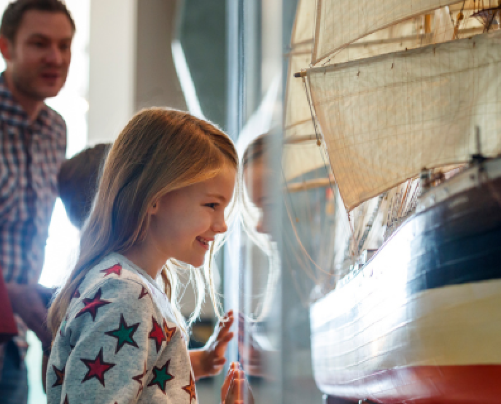 Child beams at model ship in WA Maritime Museum