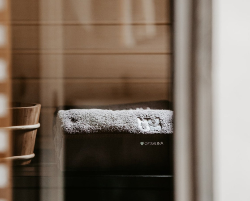 fluffy towel and wooden sauna bucket through spa windows
