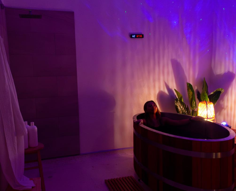 Woman soaking in wooden tub at Clear Mind Studio Fremantle in gorgeous treatment room 