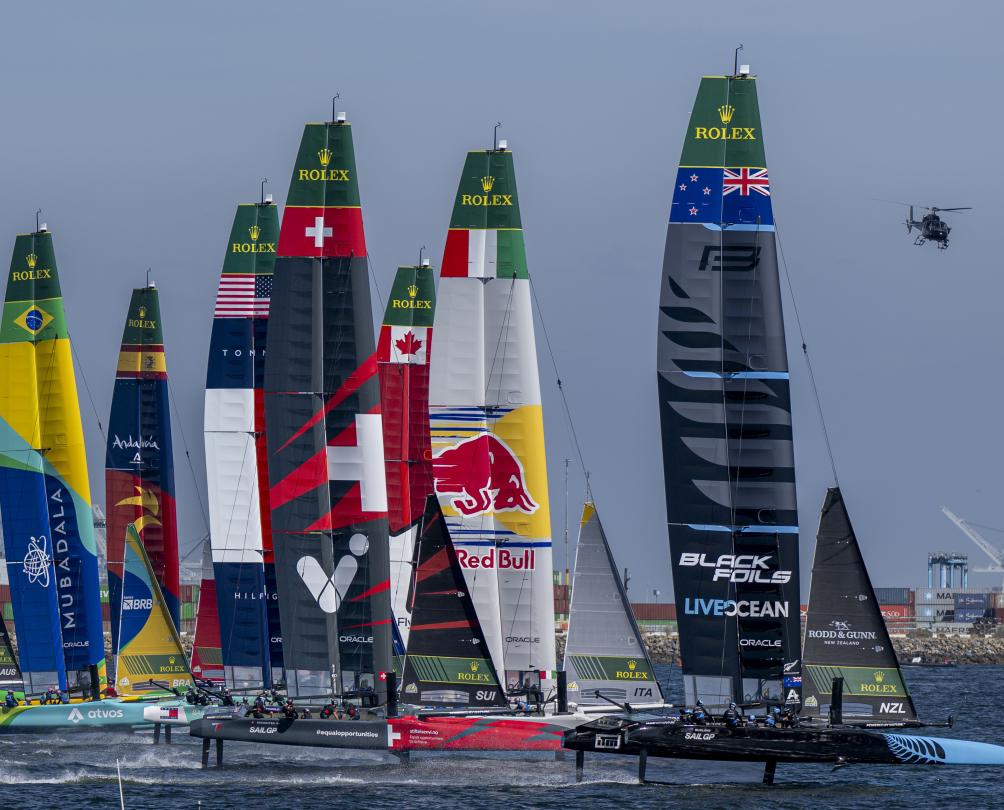 New Zealand SailGP Team helmed by Peter Burling lead over Red Bull Italy SailGP Team helmed by Ruggero Tita, Switzerland SailGP Team helmed by Sebastien Schneiter and the rest of the the SailGP feet on Race Day 1 of the Rolex Los Angeles Sail Grand Prix held in the Port of Los Angeles, California, USA. Saturday 15 March 2025. Rolex SailGP Championship Event 4 Season 2025. Photo: Jason Ludlow for SailGP. 