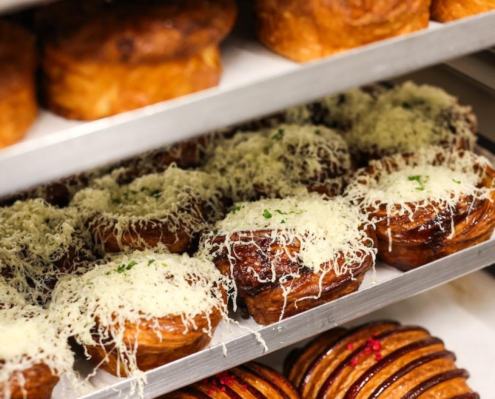 Trays filled with various pastries in an industrial setting.