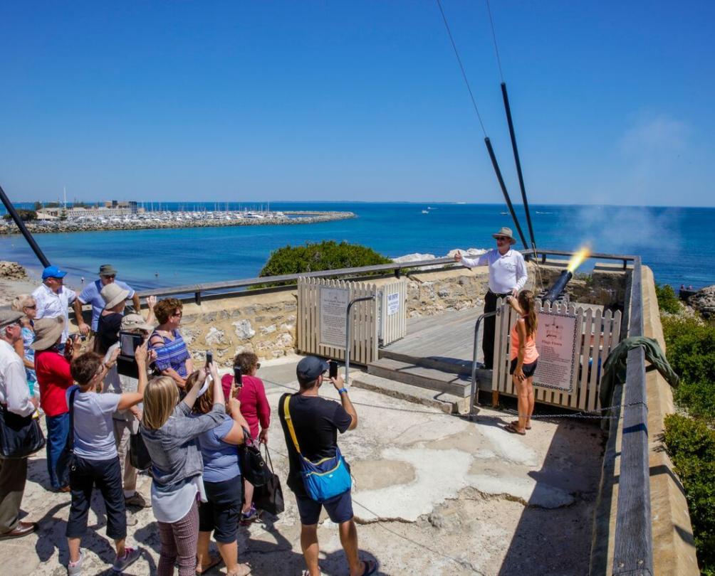tourists watching the cannon be fired at the roundhouse