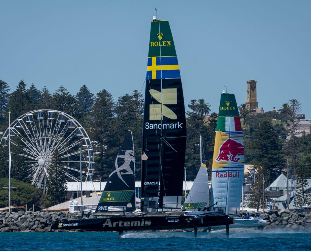 Sail GP teams racing at Bathers Beach, Fremantle with Tourist Wheel in background