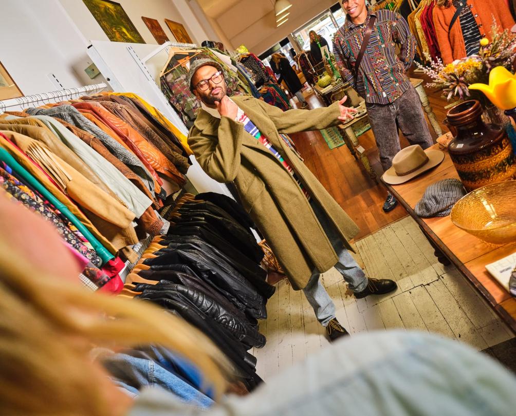 man trying on a vintage coat 