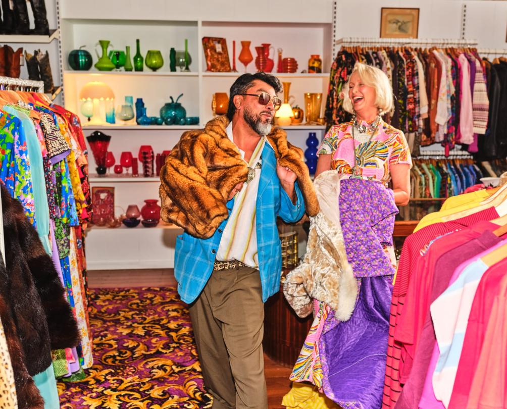 couple trying on a coat 