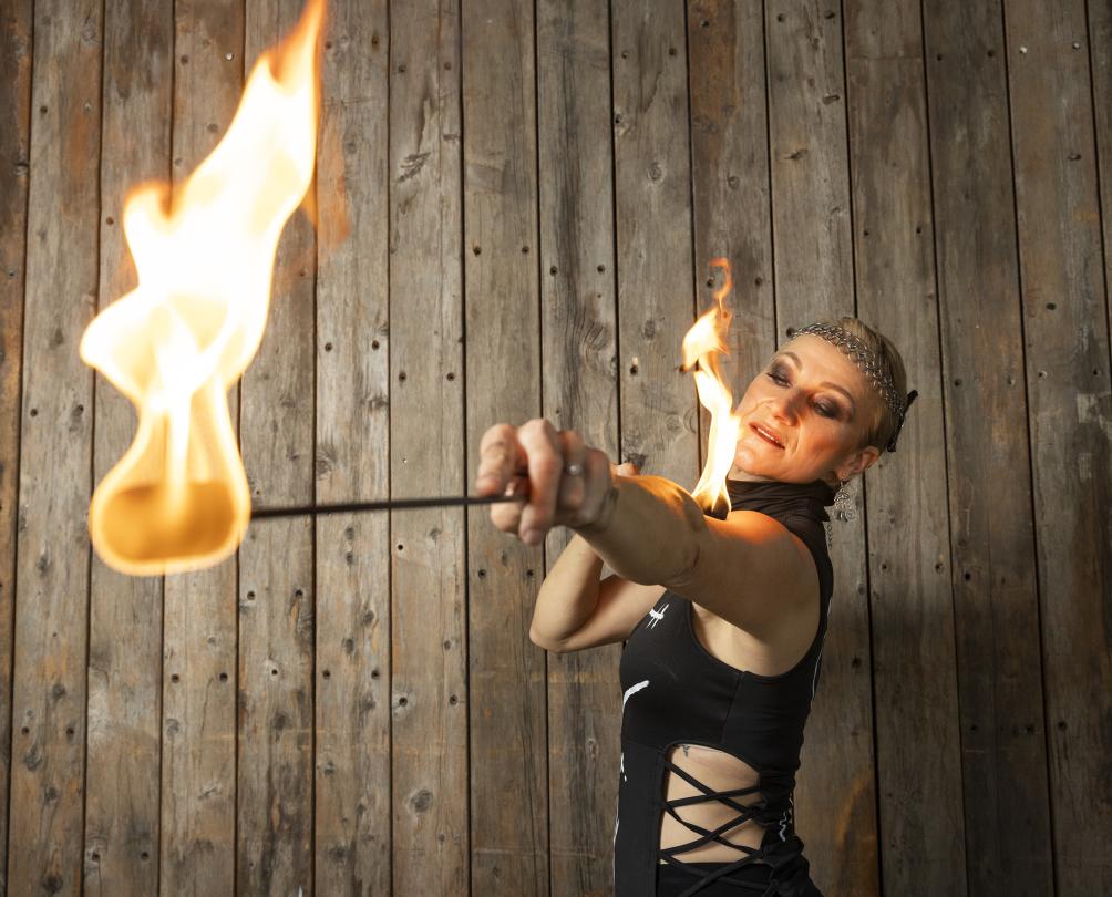 a woman doing tricks with fire