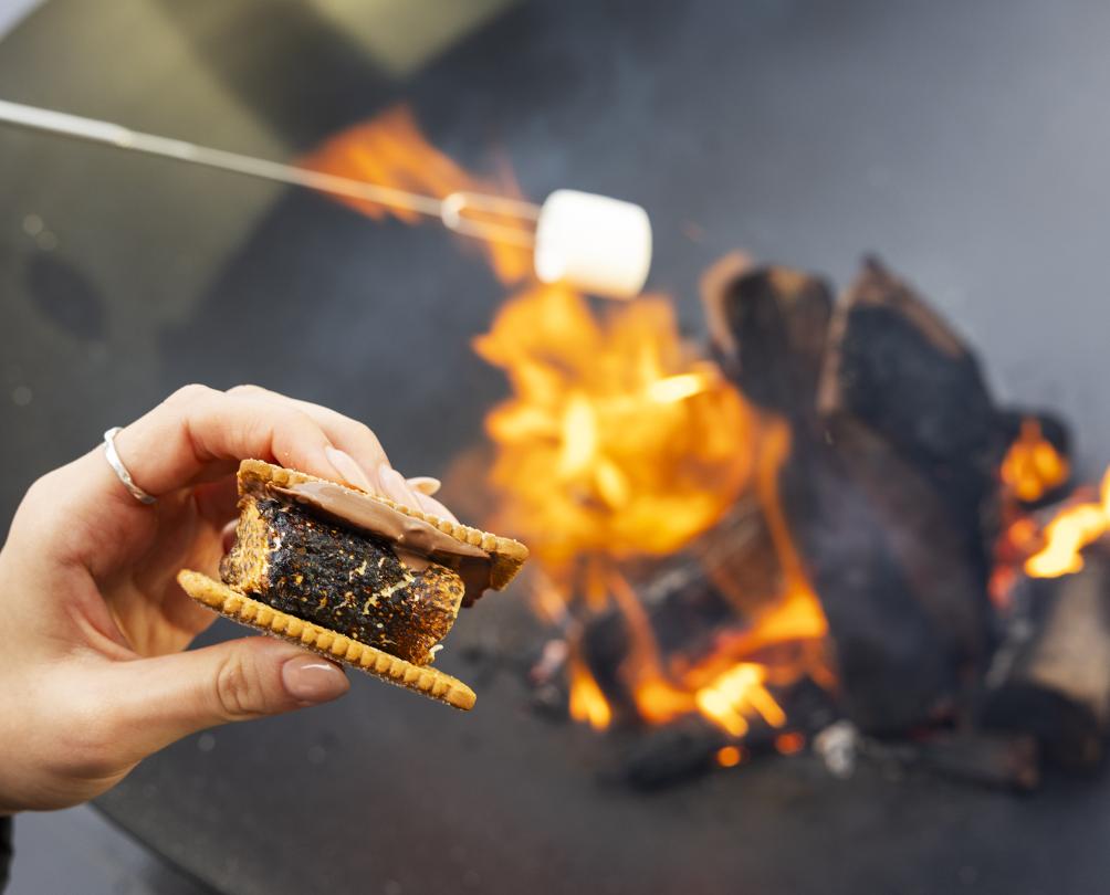 making smores and roasting marshmallows in a fire pit