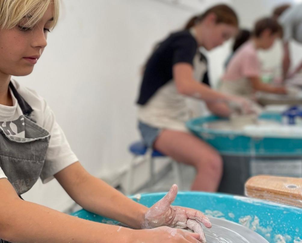 kid doing a pottery wheel 