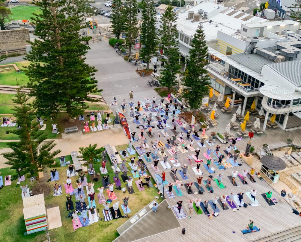 group of people doing yoga on the beach 