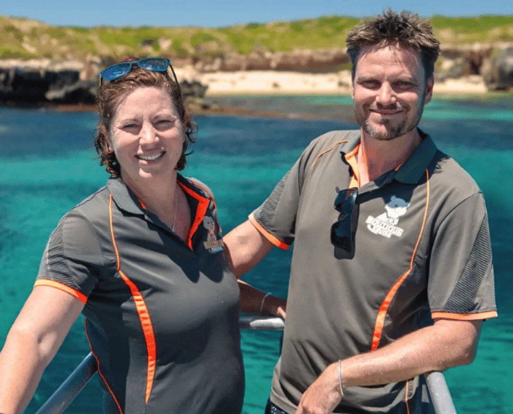 a man and a women in Bucket List Diver shirts standing on a boat in front of blue water, Fremantle WA 
