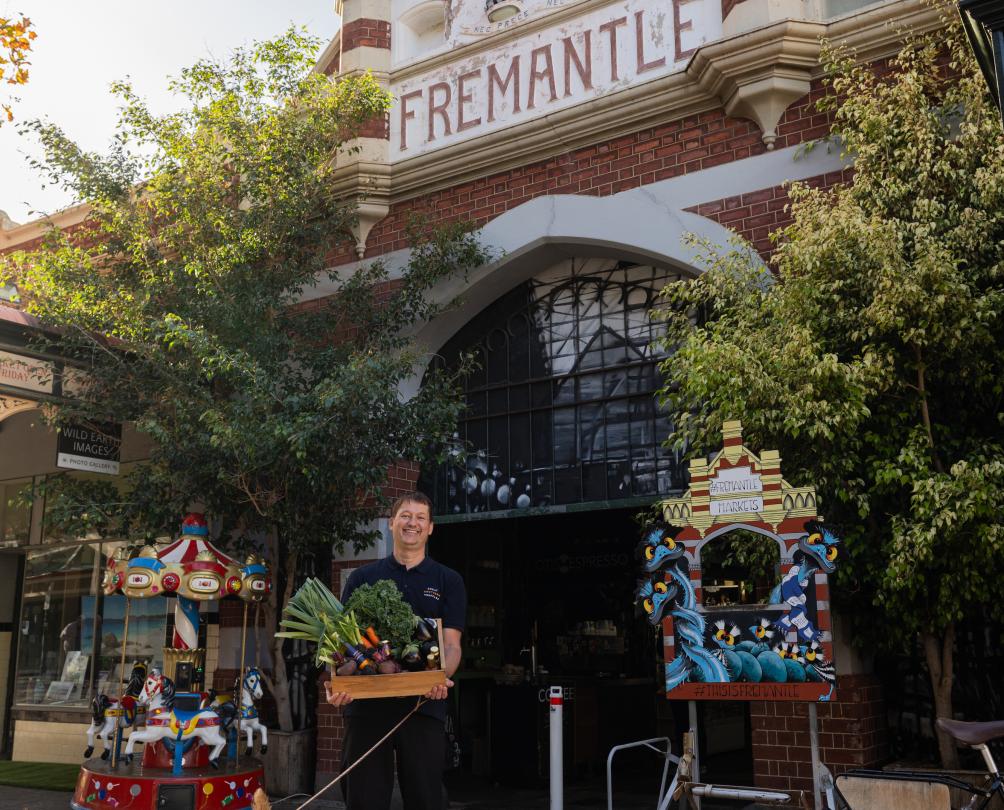 dog and man standing outside the Fremantle markets 