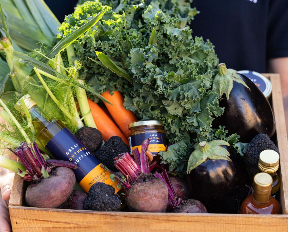 a basket of fruit and vegetables and truffle oil 