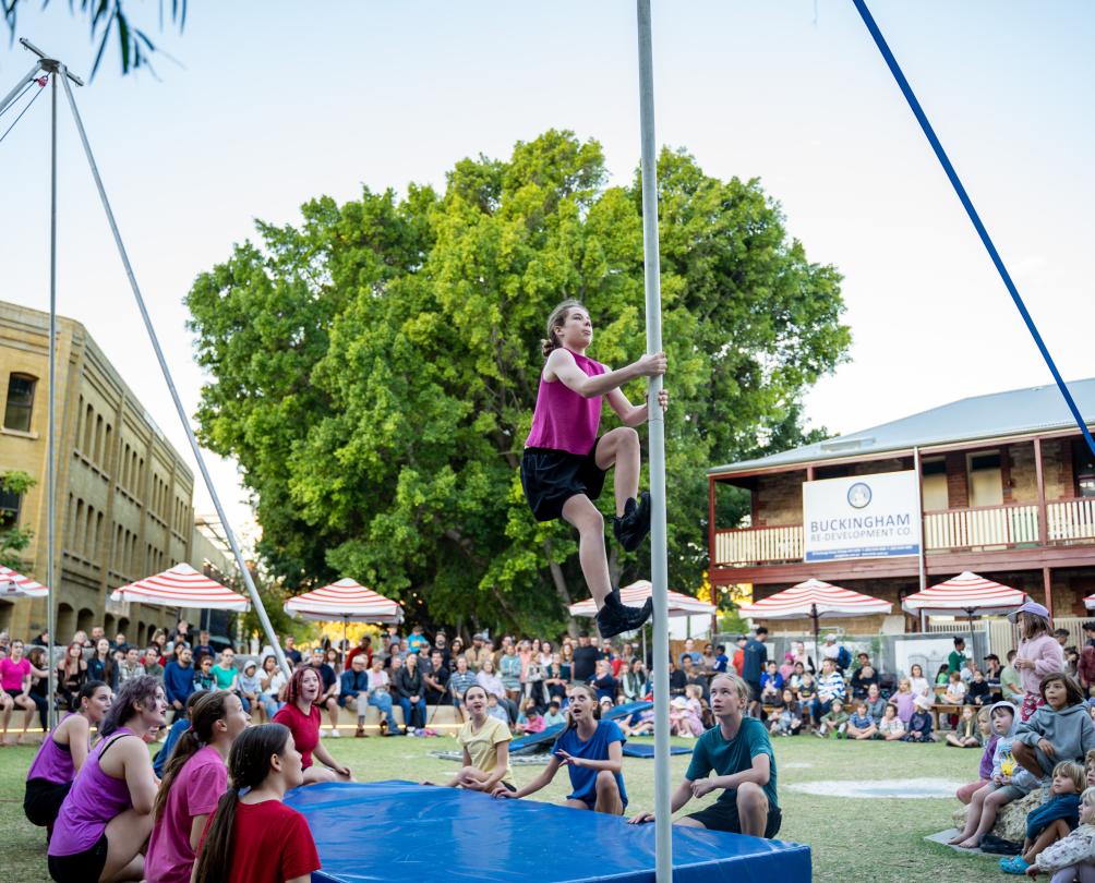 kid climbing up a pole
