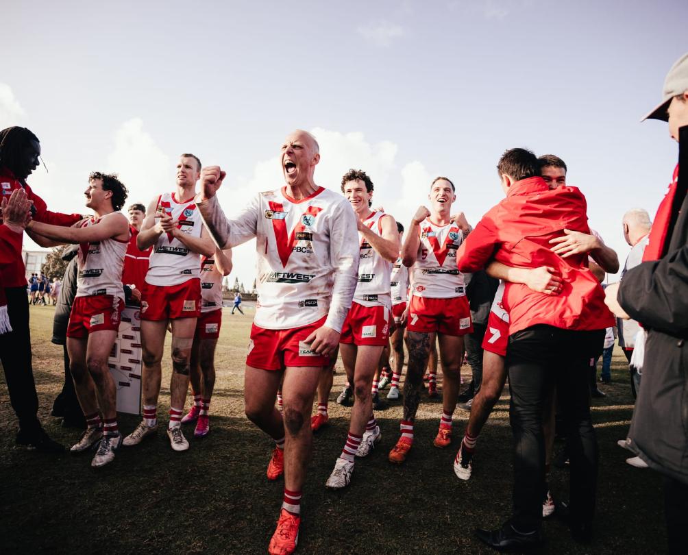 a group of footie players running onto the pitch, south fremantle oval 
