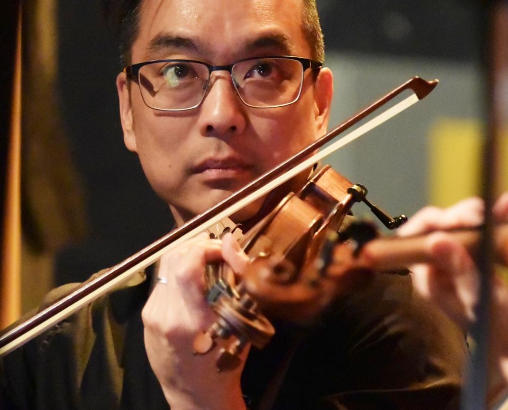 a man playing the violin for the Fremantle Chamber Orchestra