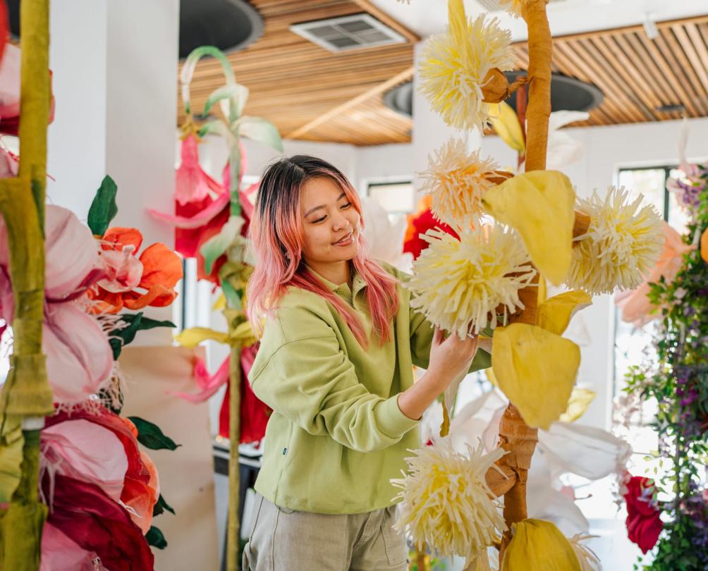 a woman making beautiful colourful paper flowers 
