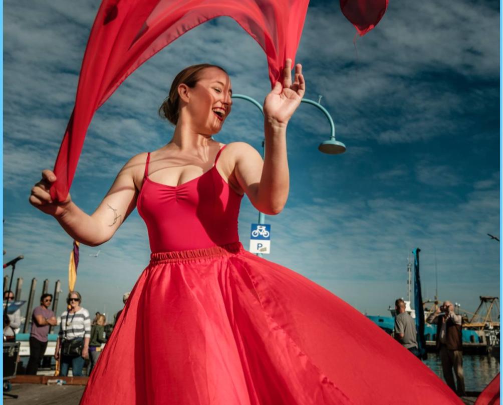 a women in red dancing at the Fishing Boat Harbour