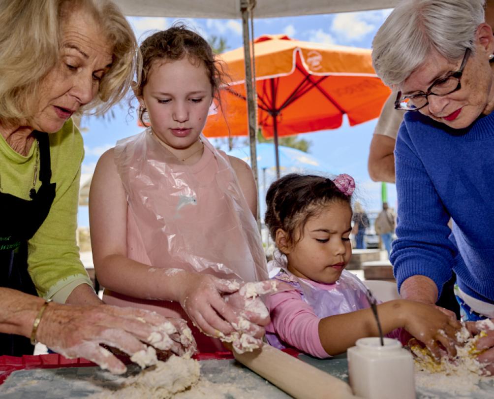 two children and some nonnas learning to cook at Fishing Boat Harbour