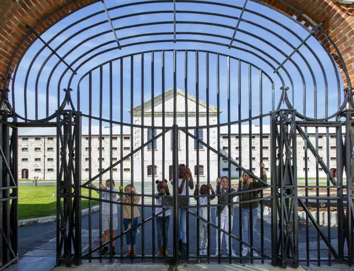 Children standing behind the gates at Fremantle Prison