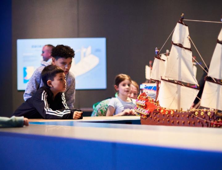 Kids looking at a ship made of LEGO at WA Maritime Museum's Brickwrecks exhibition 