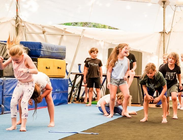 group of children learning circus tricks