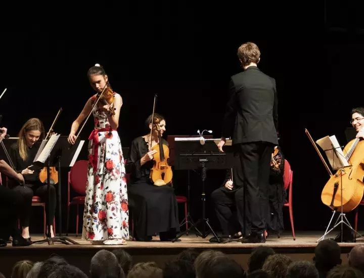 Ellie Malonzo performing with orchestra on stage at Fremantle Town Hall