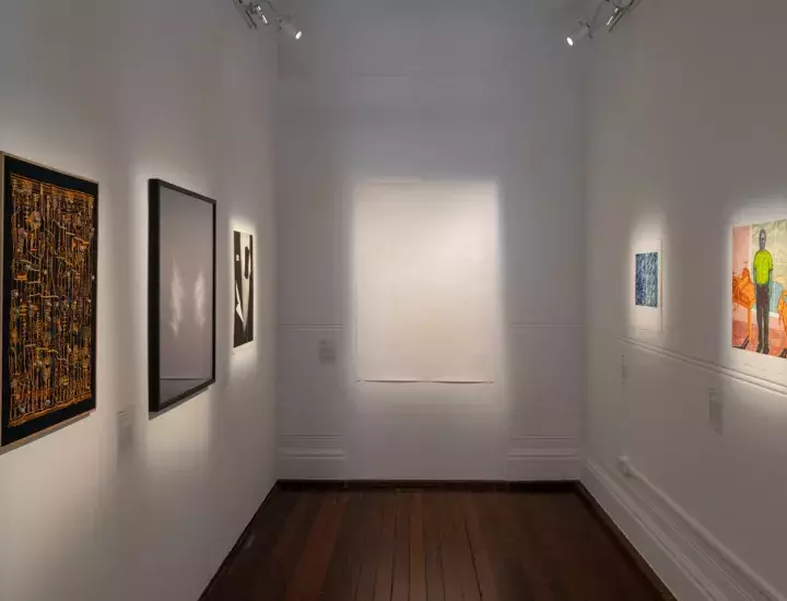 White gallery walls featuring a range of artworks.