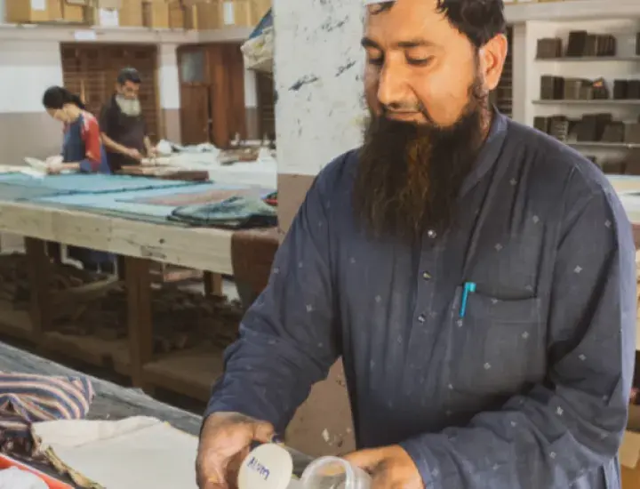 a man crafting at a table in a workshop 
